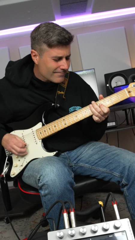Demo video thumbnail - Vincenzo De Caro playing guitar in studio with a Darkglass Anagram in foreground