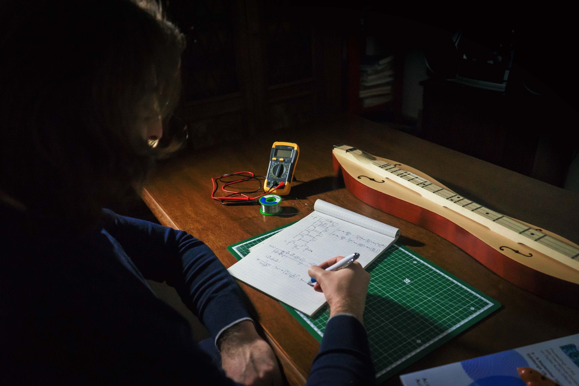 Me at the desk with a few random items (dulcimer, ocarina, DAFx book, multimeter, tin solder)